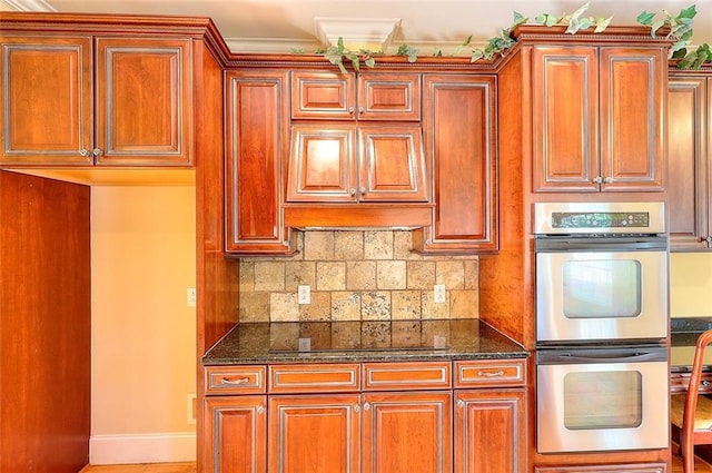 1595 Lake Lucerne Rd SW, Lilburn, GA 30047 - kitchen featuring stainless steel double oven, dark stone countertops, baseboards, and black electric stovetop