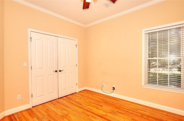 1595 Lake Lucerne Rd SW, Lilburn, GA 30047 - unfurnished bedroom with baseboards, light wood-style flooring, ornamental molding, a closet, and ceiling fan