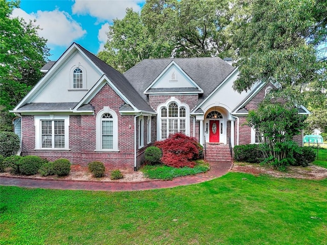 1595 Lake Lucerne Rd SW, Lilburn, GA 30047 - view of front facade with a front yard and brick siding