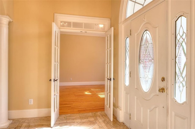 1595 Lake Lucerne Rd SW, Lilburn, GA 30047 - entryway featuring plenty of natural light, baseboards, french doors, and ornate columns