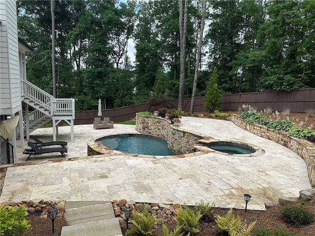 view of pool featuring an in ground hot tub and a patio