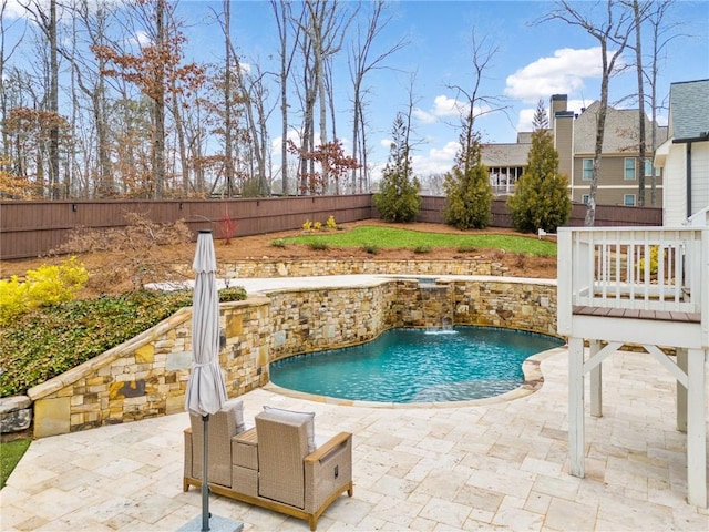 view of swimming pool with pool water feature and a patio