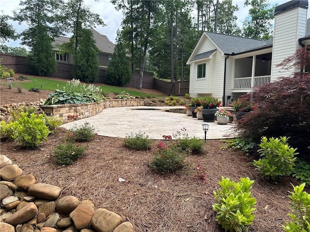 view of yard featuring ceiling fan and a patio area