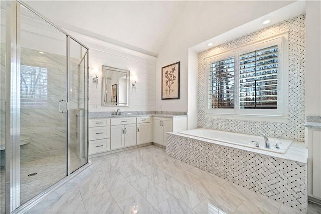 bathroom featuring lofted ceiling, plus walk in shower, and vanity