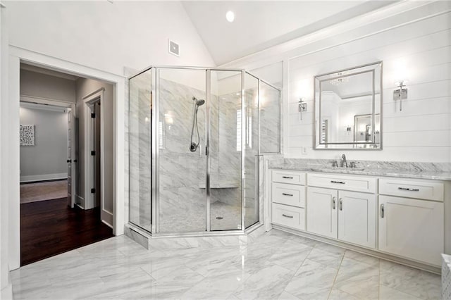 bathroom featuring lofted ceiling, an enclosed shower, and vanity