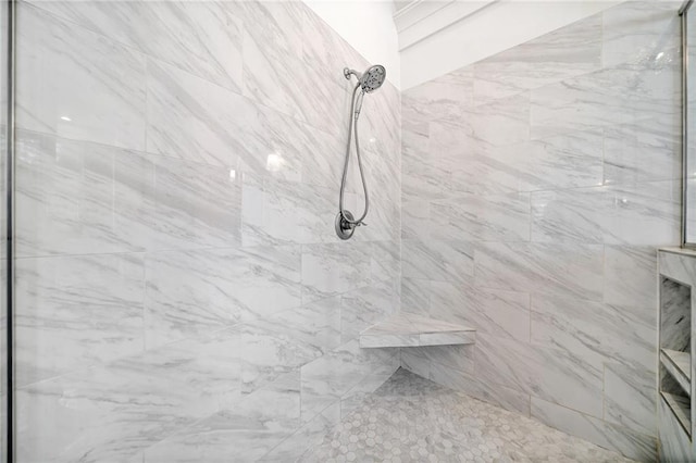 bathroom with a tile shower