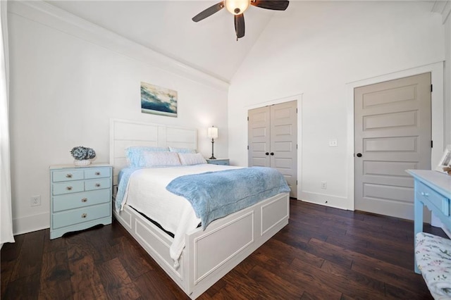 bedroom featuring ceiling fan, lofted ceiling, dark hardwood / wood-style flooring, and a closet