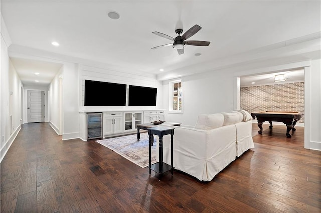 living room with ceiling fan, billiards, brick wall, and dark hardwood / wood-style flooring