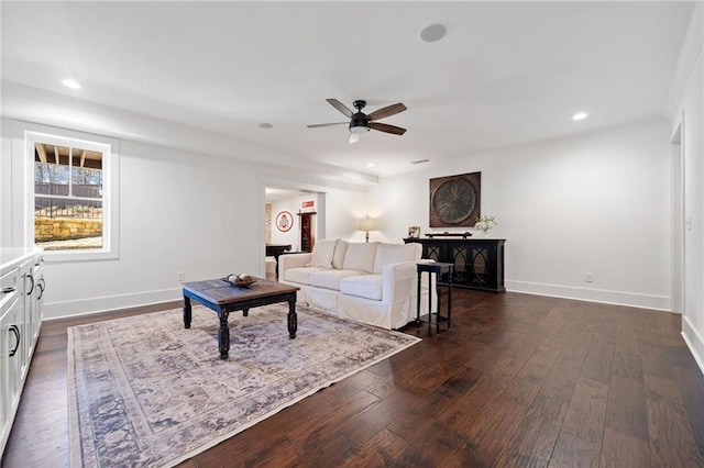 living room featuring ceiling fan and dark hardwood / wood-style flooring