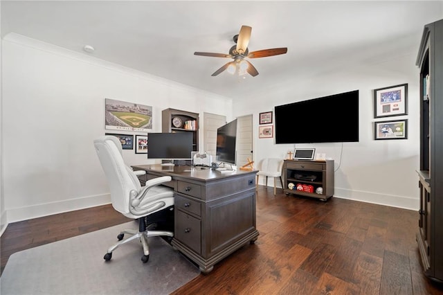 home office with dark wood-type flooring, ornamental molding, and ceiling fan