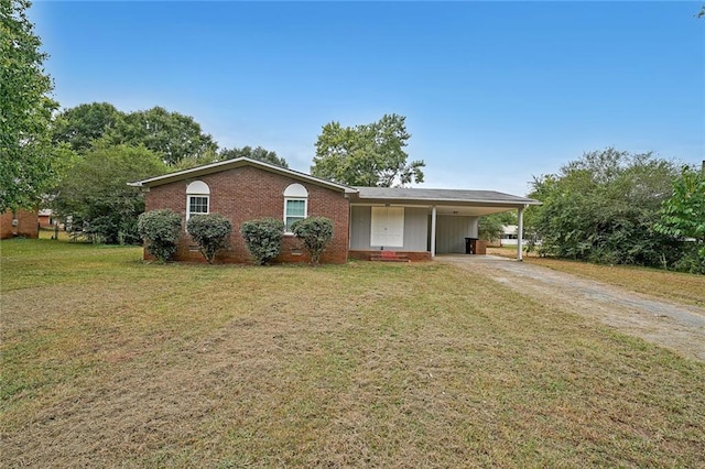 ranch-style house featuring a carport and a front lawn