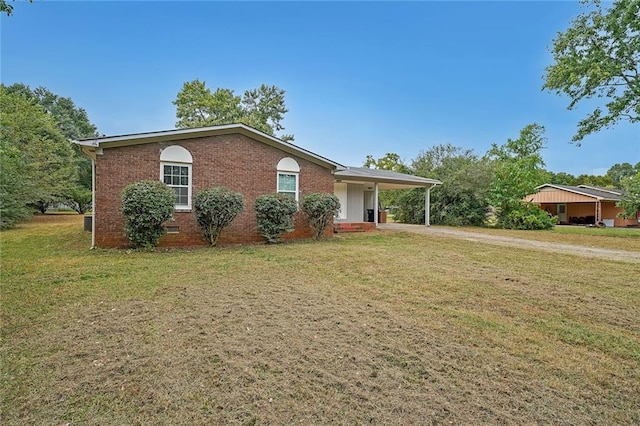 single story home featuring a carport and a front lawn