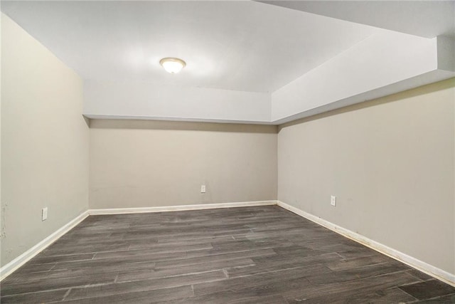 bonus room with dark wood-style floors and baseboards