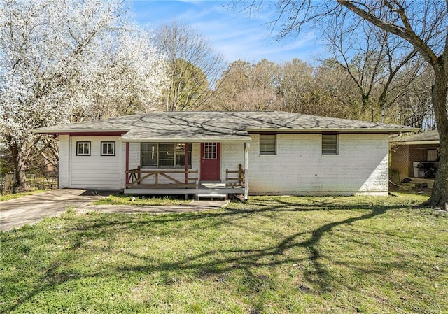 ranch-style house with brick siding and a front yard