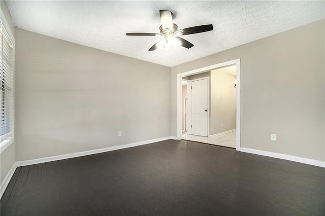 unfurnished bedroom featuring a ceiling fan, baseboards, and a textured ceiling