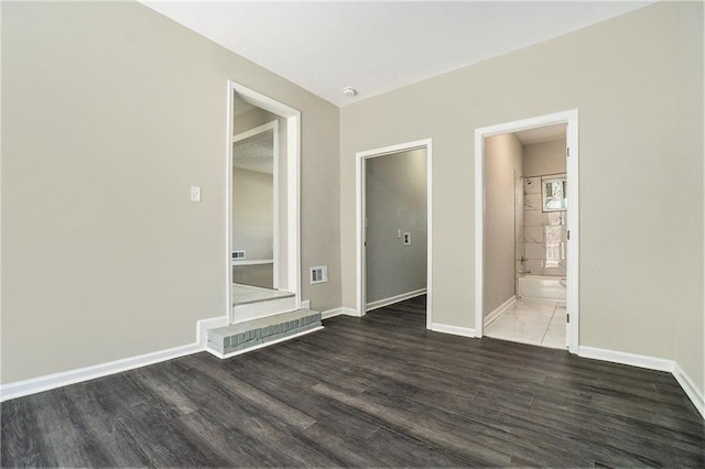 interior space featuring baseboards and wood finished floors