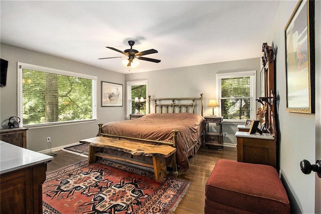 6590 Williamson Dr NE, Atlanta, GA 30328 - bedroom featuring multiple windows, baseboards, dark wood finished floors, and ceiling fan