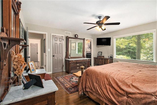6590 Williamson Dr NE, Atlanta, GA 30328 - bedroom featuring dark wood-style floors, a ceiling fan, and baseboards
