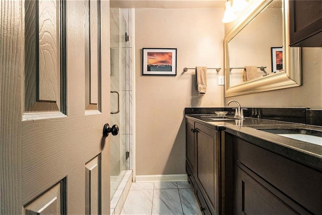 6590 Williamson Dr NE, Atlanta, GA 30328 - bathroom with marble look tiles, vanity, a stall shower, and baseboards