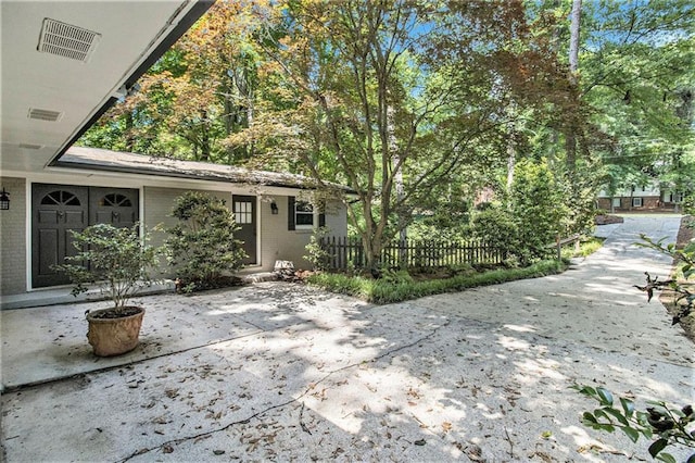6590 Williamson Dr NE, Atlanta, GA 30328 - view of front facade with brick siding and a patio
