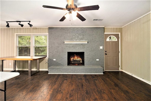 6590 Williamson Dr NE, Atlanta, GA 30328 - unfurnished living room featuring ceiling fan, a fireplace, wood finished floors, rail lighting, and ornamental molding
