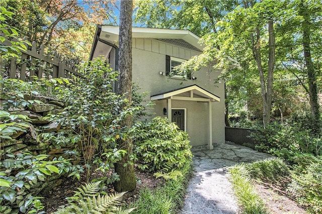 6590 Williamson Dr NE, Atlanta, GA 30328 - view of front of home featuring brick siding, a patio area, and board and batten siding
