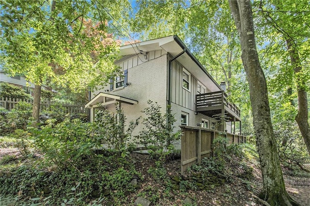 6590 Williamson Dr NE, Atlanta, GA 30328 - view of side of home featuring brick siding, board and batten siding, and a balcony