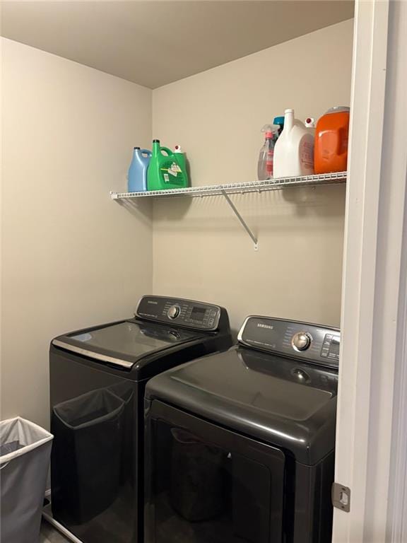 clothes washing area with washing machine and dryer and laundry area