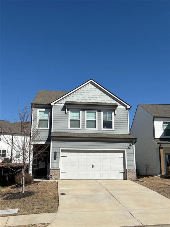 view of front facade with driveway, a garage, and brick siding