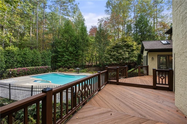 view of swimming pool with a wooden deck