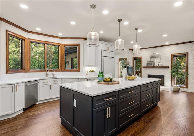 kitchen with white cabinetry, hanging light fixtures, and dishwasher