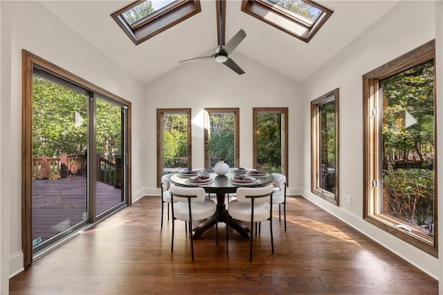 sunroom with vaulted ceiling with skylight, a wealth of natural light, and ceiling fan