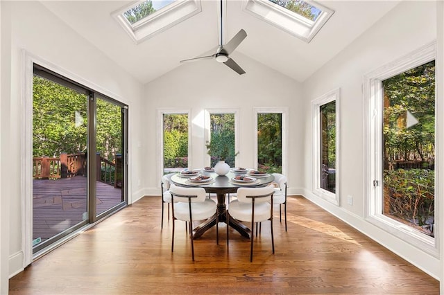 sunroom featuring vaulted ceiling with skylight and ceiling fan