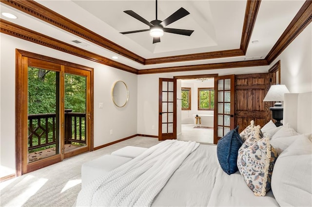 carpeted bedroom with access to exterior, ornamental molding, french doors, and a raised ceiling