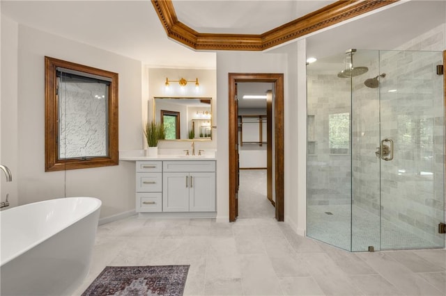 bathroom featuring crown molding, vanity, and shower with separate bathtub