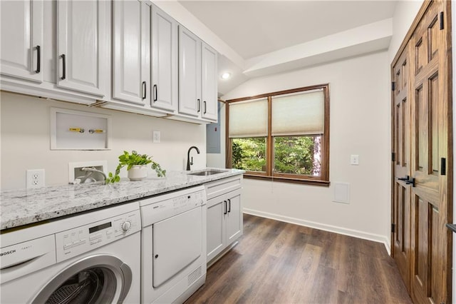 washroom featuring sink, dark hardwood / wood-style floors, cabinets, and independent washer and dryer