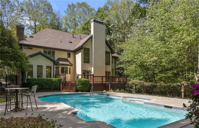 view of pool featuring an in ground hot tub, a deck, and a patio area