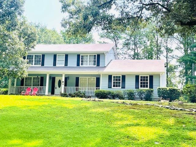 view of front of home with covered porch and a front yard