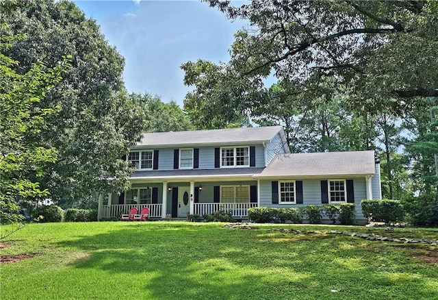 view of front of property with covered porch and a front lawn