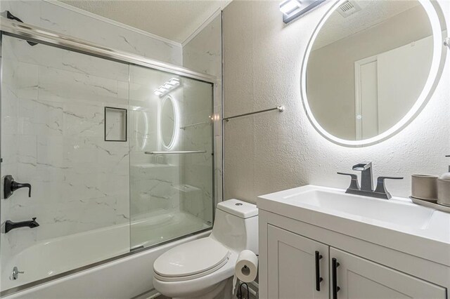 full bathroom featuring vanity, enclosed tub / shower combo, and toilet