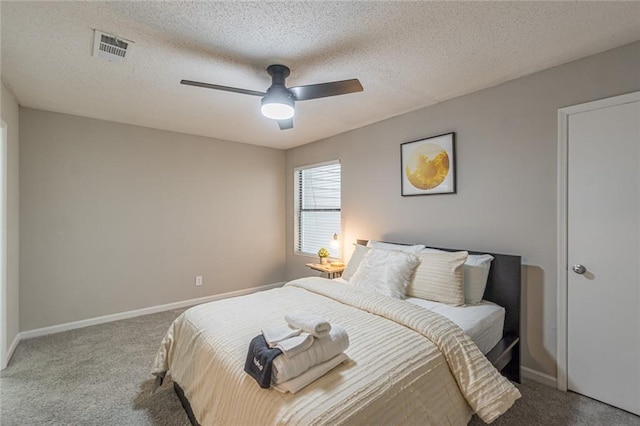 bedroom featuring carpet, ceiling fan, and a textured ceiling