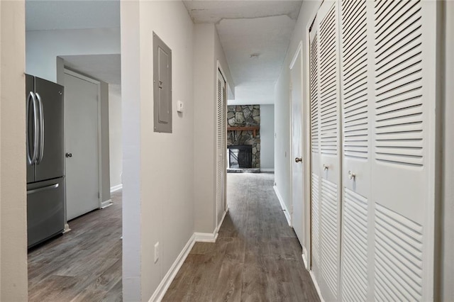 hall with dark hardwood / wood-style floors and electric panel