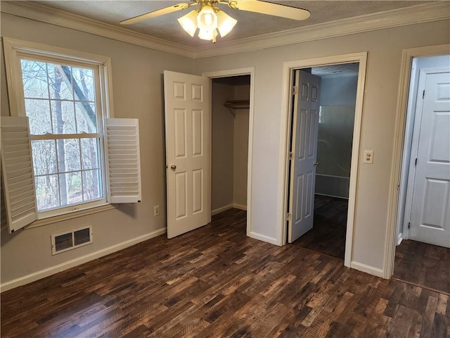 unfurnished bedroom featuring crown molding, ceiling fan, dark hardwood / wood-style flooring, and a closet