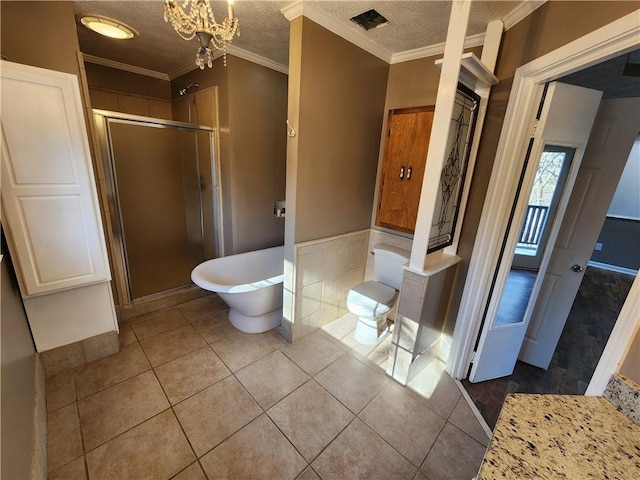 bathroom with ornamental molding, tile patterned floors, shower with separate bathtub, and a textured ceiling