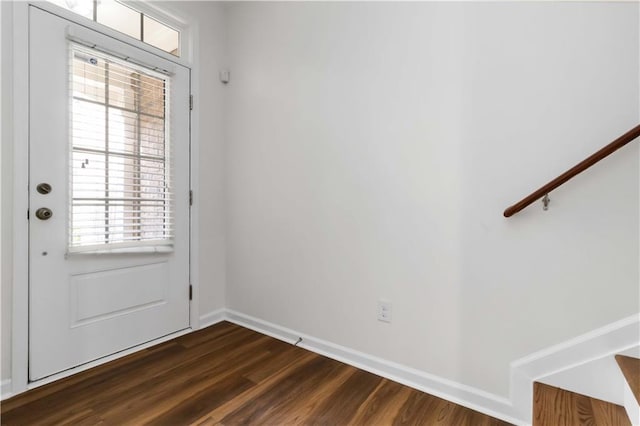 doorway to outside with dark wood-style flooring, baseboards, and stairway