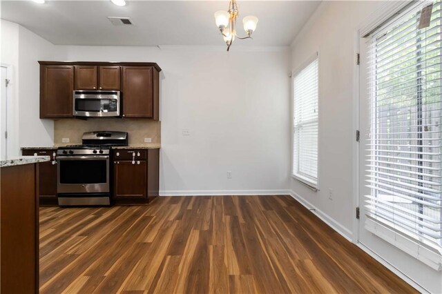 kitchen with stainless steel appliances, dark wood-style floors, a chandelier, and dark brown cabinetry