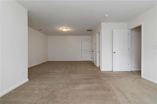 empty room with carpet and baseboards