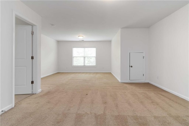 empty room with light carpet and baseboards