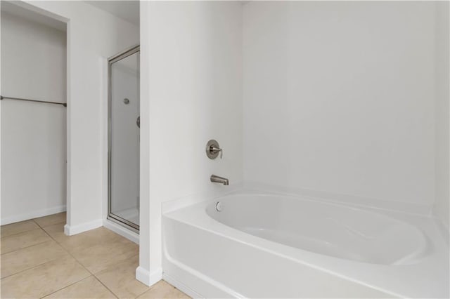 full bathroom with tile patterned floors, a shower with shower door, a bathtub, and baseboards