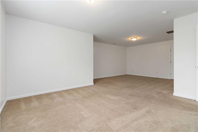 unfurnished room with carpet, baseboards, and a smoke detector